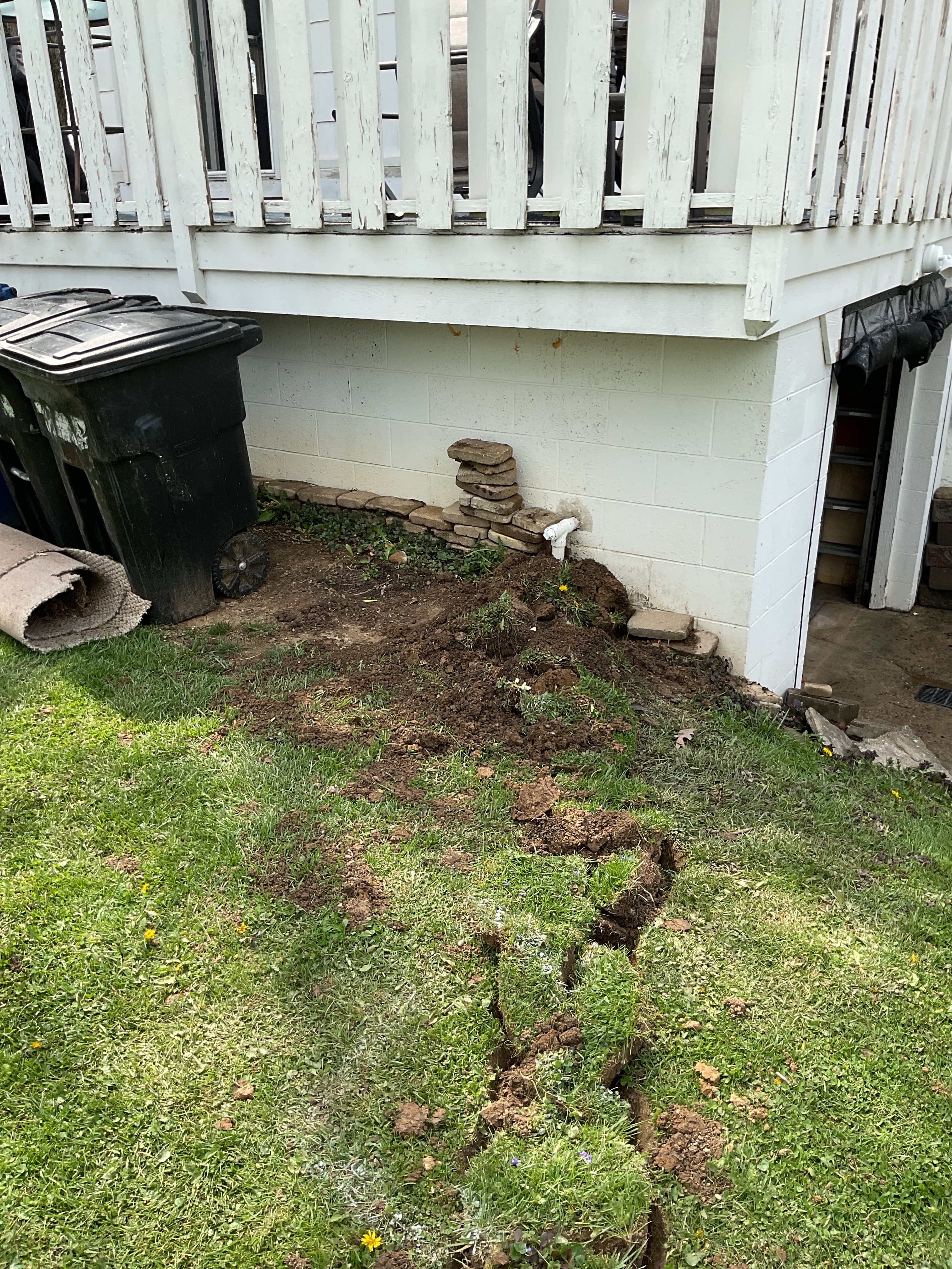Buried sump pump discharge line exit point at the foundation of a Columbus Ohio home