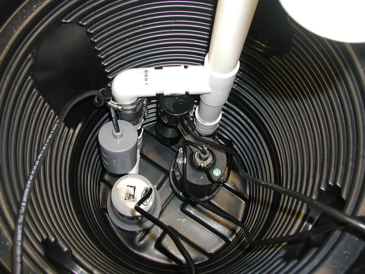 New high-efficiency sump pump being installed in basement