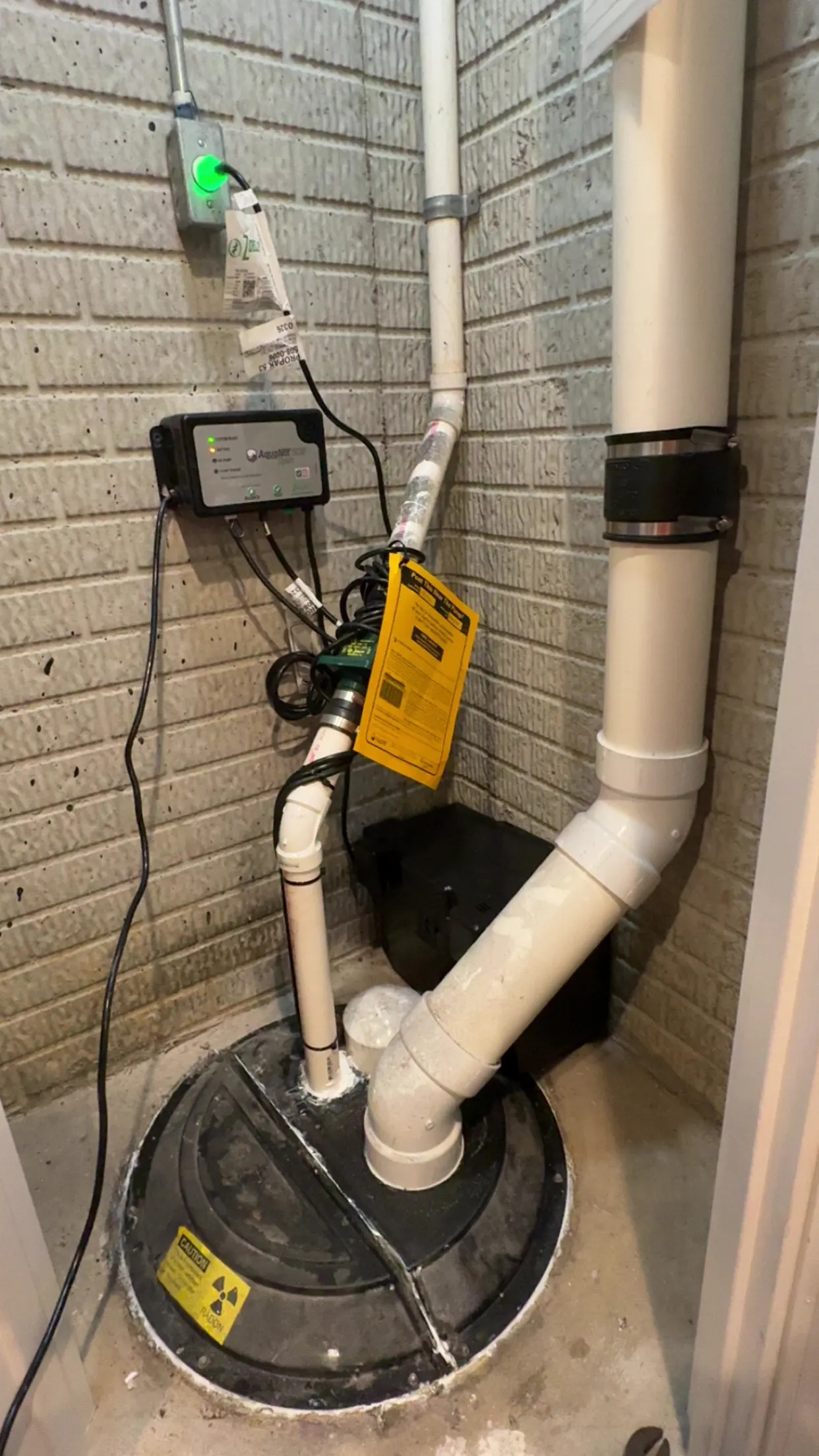 AquaNOT battery-backup sump pump installed in a Central Ohio basement by Allegiant Plumbing